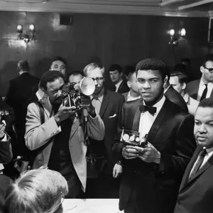 Cassius Clay holds a case with 24 carrot gold coins in memory of Sir Winston Churchill Cassius Clay holds a case with 24 carrot gold coins in memory of Sir Winston Churchill