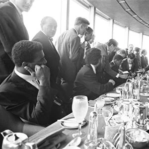 Cassius Clay seen here signing autographs whilst he was attending a lunch at the top of