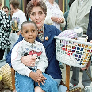 The cast of EastEnders on set. June Brown as Dot Cotton with a young cast member