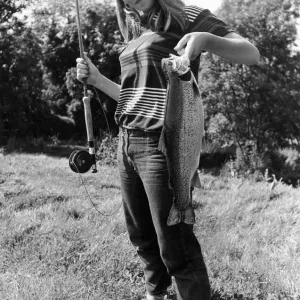 Celia Reade, aged 14 seen here shortly after landing a trout following a fishing lesson