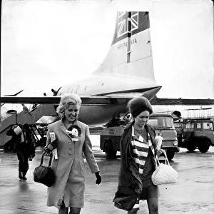 Celtic wives fly home to Prestwick Airport, Scotland, and into the rain