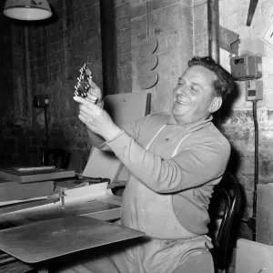 Chad Valley Toy company, Birmingham, West Midlands. Pictured cutting jigsaw puzzles is Mr