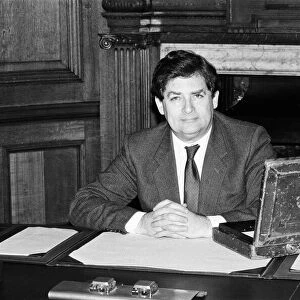 Chancellor of the Exchequer Nigel Lawson at his desk with the Budget case