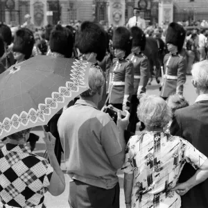 Changing of the Guard in London today. An umbrella serves as a sun-shade for a spectator Changing of the Guard in London today. An umbrella serves as a sun-shade for a spectator