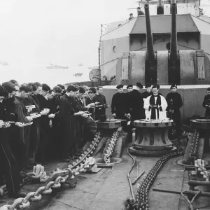 A chaplain takes Sunday service on board HMS Scylia while at anchor off the Normandy A chaplain takes Sunday service on board HMS Scylia while at anchor off the Normandy