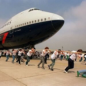 Charity Aircraft Pull. A British Airways Boeing 747 Jumbo Jet is pulled along the tarmac