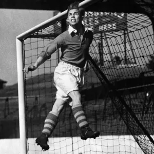 Charlton Athletic left half Bert Johnson practicing heading the ball out from under