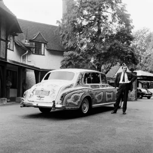 The chauffeur of The Beatles singer John Lennon standing beside Lennon The chauffeur of The Beatles singer John Lennon standing beside Lennon