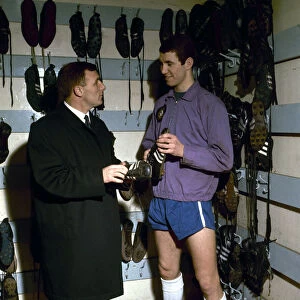 Chelsea footballer Peter Osgood in the boot room at Stamford Bridge with his manager