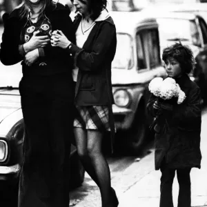 A child selling paper flowers on the streets of Newcastle on 27th December 1974