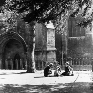 Childhood confidences in the playground of the girls school beside the walls of Tewesbury Childhood confidences in the playground of the girls school beside the walls of Tewesbury
