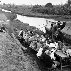 Children of barge familys seen here being educated on the canal bank by a floating