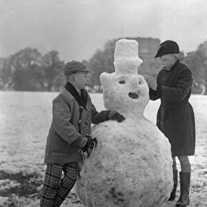 Children build a snowman in a Bristol park 31st December 1961
