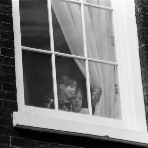 The children of Chancellor of the Exchequer Nigel Lawson watching from a window of 11