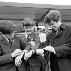 Three children check their watches against local US time on arrival in New York Three children check their watches against local US time on arrival in New York