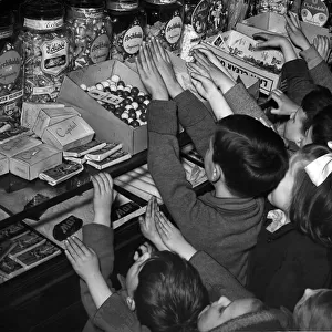 Children invade sweet shop after rationing ends in Glasgow, Scotland. 1949