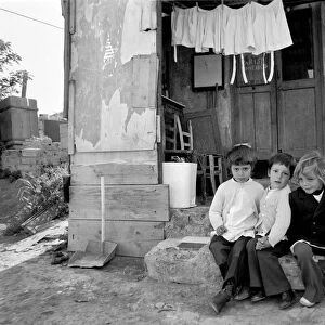 Children outside their home in a poor suburb on the outskirts of Rome