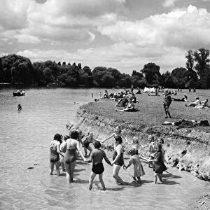 Children paddling in the River Thames at Eton opposite Windsor, Berkshire