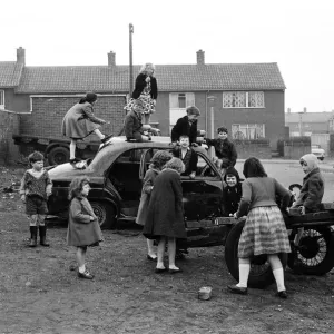 Children play on the wreck of a dumped car at Kirkby, Liverpool. 18th March 1965 Children play on the wreck of a dumped car at Kirkby, Liverpool. 18th March 1965