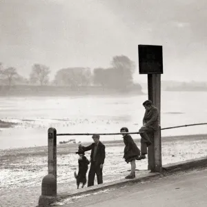 Children playing on the banks of the River Thames, Chiswick, London