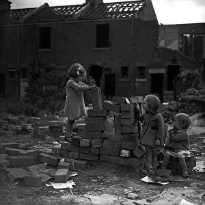 Children playing on bomb site after a bombing raid in London during WW2