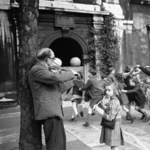 Children playing Oranges and Lemons in the Church of St Clement Danes London. Circa 1946