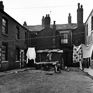 Children playing outside slum housing Number Two Court, Dickenson Street, Oldham