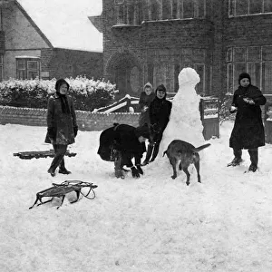 Children playing in the snow, Surrey. Circa 1925. Tyrell Collection