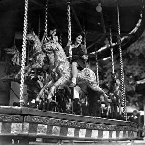 Children ride the Merry-Go-Round at the Surbiton fair. Circa 1930