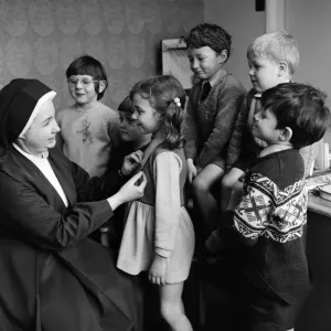 Children at Sacred Heart School, having a shamrock pined to them. 17th March 1971 Children at Sacred Heart School, having a shamrock pined to them. 17th March 1971