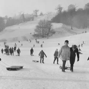 Children take the slopes of a Bristol park after a fresh fall of snow. 2nd January 1962 Children take the slopes of a Bristol park after a fresh fall of snow. 2nd January 1962