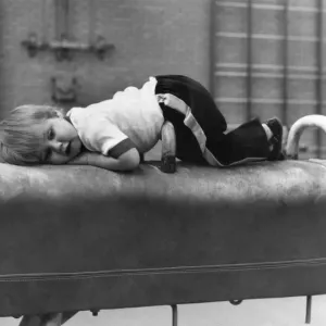 Children: Sports: Taking a break: After a work-out, Sean lies down on a vaulting horse Children: Sports: Taking a break: After a work-out, Sean lies down on a vaulting horse