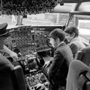 Children Transport Aviation. Children looking at the controls of a TWA 707 plane in Children Transport Aviation. Children looking at the controls of a TWA 707 plane in