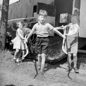 Children unloading a racing sulky, the light frame the jockey rides in during a trotting Children unloading a racing sulky, the light frame the jockey rides in during a trotting