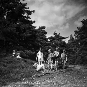 Children walking through the countryside. Circa 1940