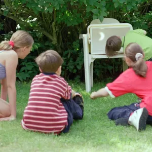 Children watching the solar eclipse indirectly at Hightown. 11th August 1999