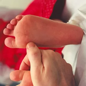 A childs feet being inspected