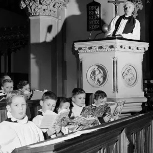 Choirboys reading their books in church during a priests sermon Circa 1954 Choirboys reading their books in church during a priests sermon Circa 1954