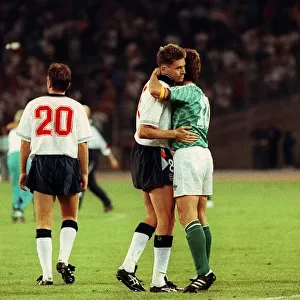 Chris Waddle Football is consoled and embraced by Lothar Matthaus of W Germany after