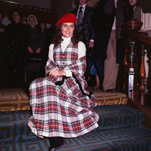 Cindy Breakspeare Miss World 1977 wearing tartan outfit dress sitting on stairs