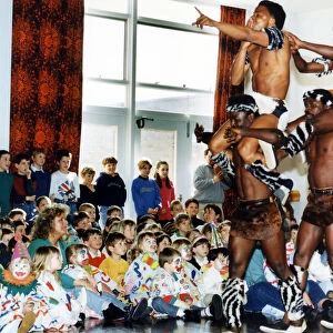Circus visits Redcar, children dressed as clowns watching performers from a circus