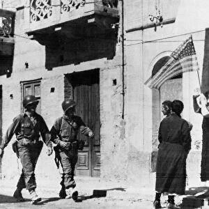Citizens of Barcelona, Sicily, welcome US Troops with the US flag