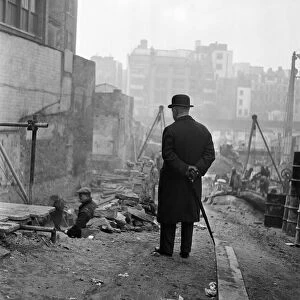 A city gent watching men working in Leadenhall Street, London. March 1954