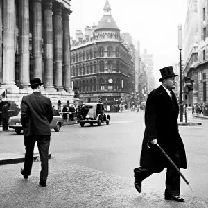 City types walk at Mansion House, umbrellas in hand. 23rd January 1959