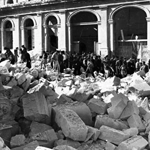 Civilians collect at the entrance to an air raid shelter as the sirens sounds, Valetta