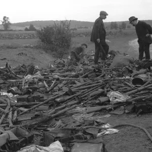 Civilians look at heap of rifles left in the field by the Germans during World War Civilians look at heap of rifles left in the field by the Germans during World War