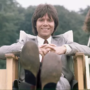 Cliff Richard seen here relaxing between takes on location filming for "