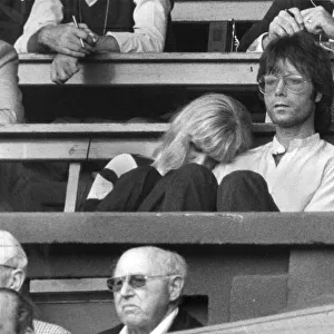 Cliff Richard with Sue Barker leaning on his arm watching Wimbledon tennis - June 1982