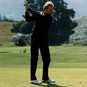 Clint Eastwood actor swinging driver teeing off golf Kings course Gleneagles