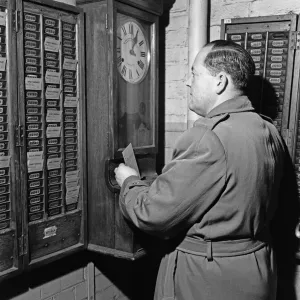 Clocking on at the Daily Herald newspaper offices. 18th December 1959 Clocking on at the Daily Herald newspaper offices. 18th December 1959